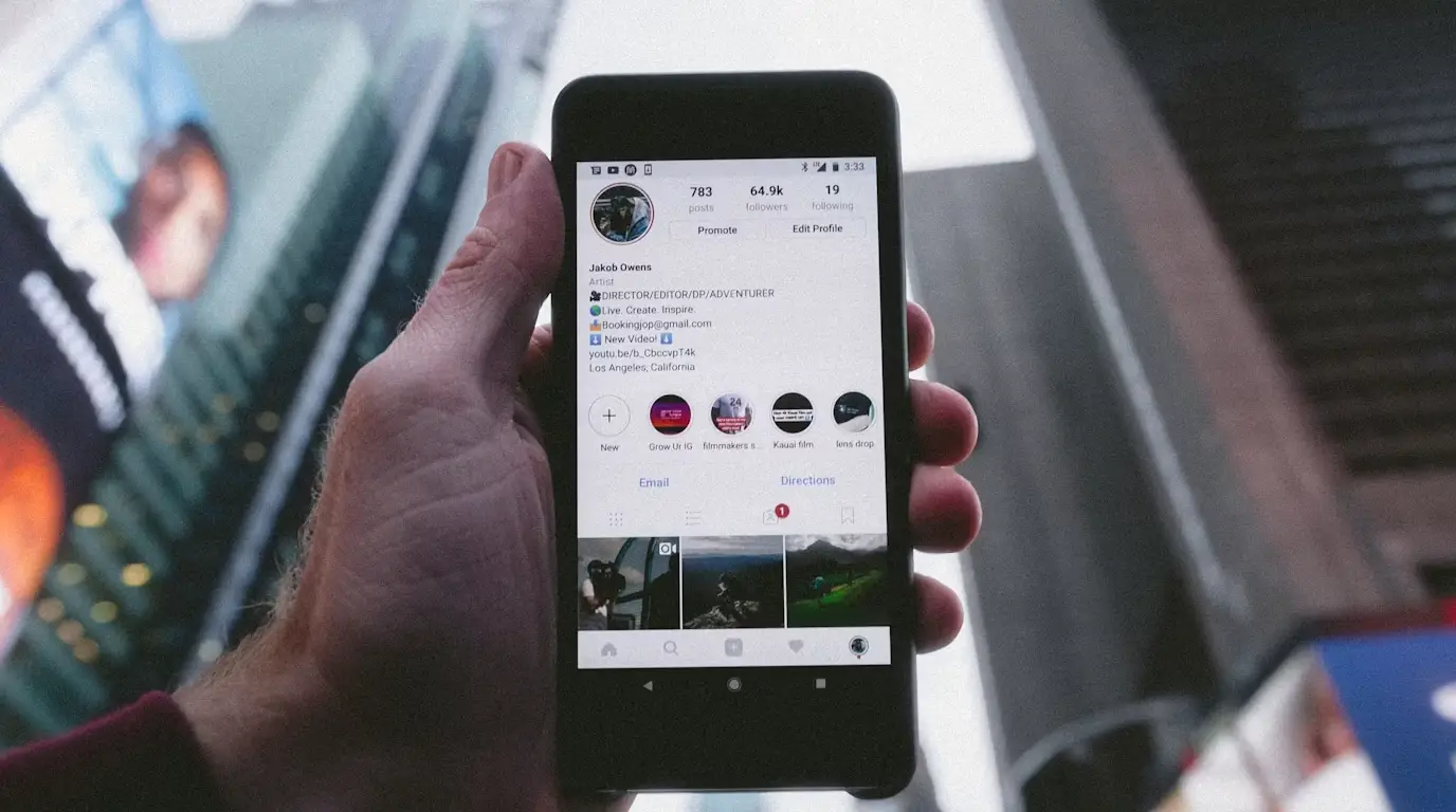 A phone showing Instagram in Times Square, NYC