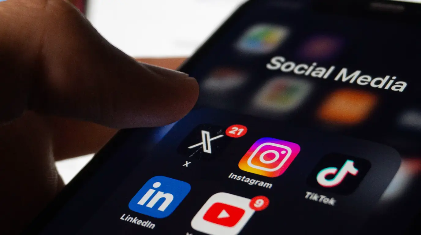 A close up of an iPhone folder with social media icons organized neatly.